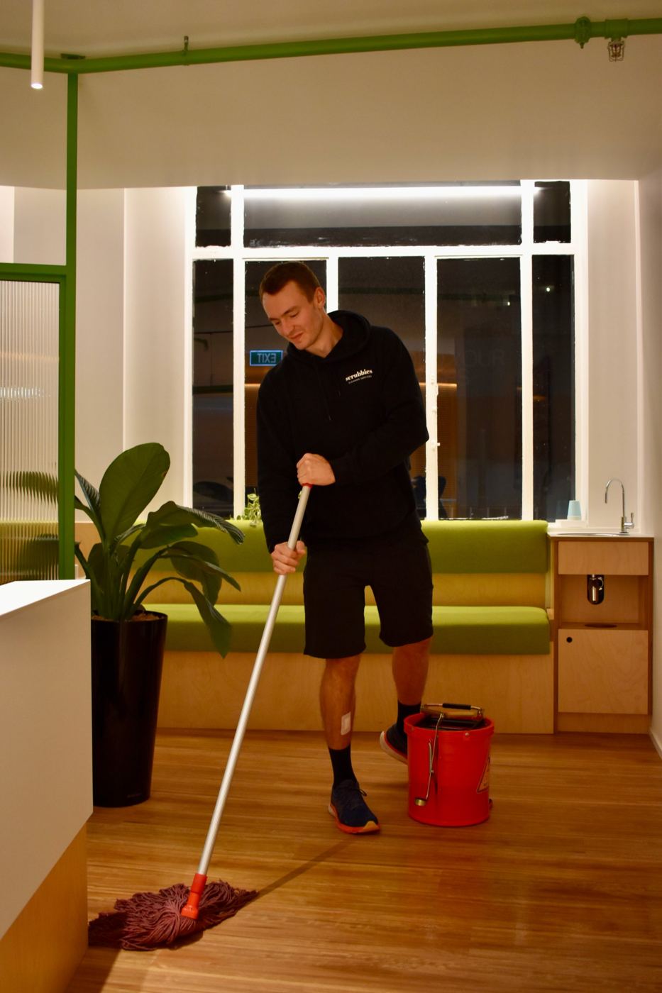 Scrubbies team member mopping a reception area